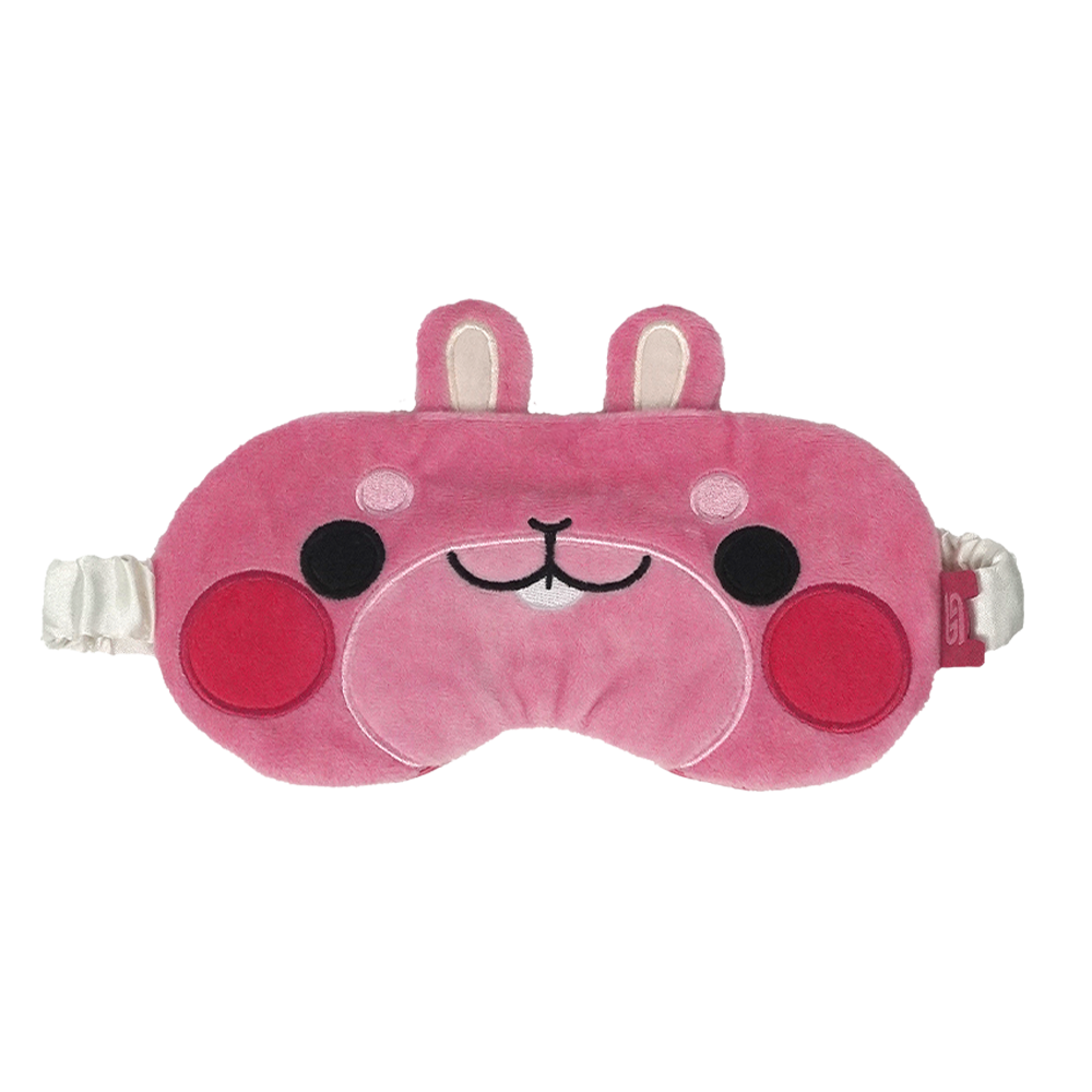 A pink plush sleep mask with a cute cartoon face, featuring bunny ears on top, embroidered facial details, and white elastic straps on both sides, shown against a plain white background.
