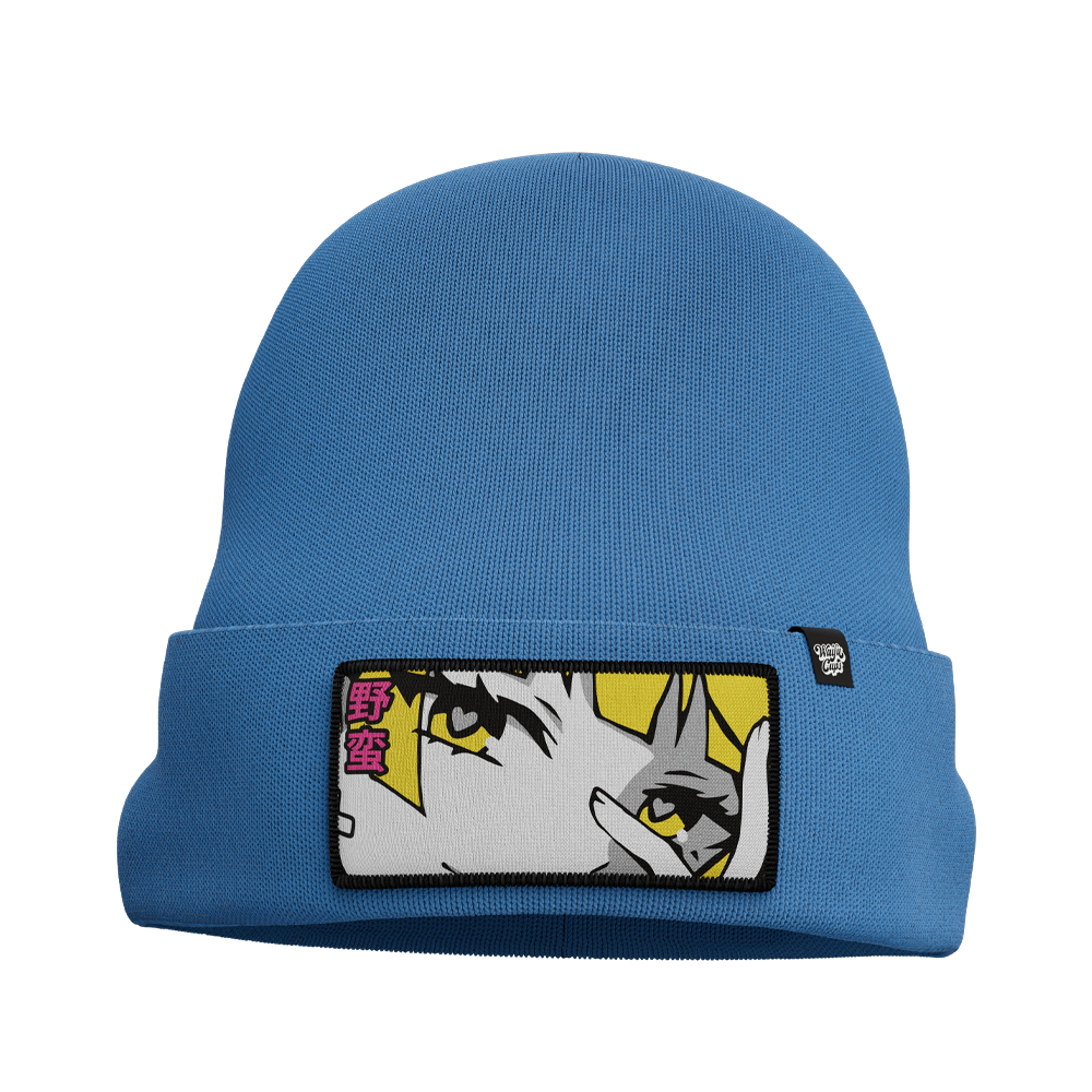 Blue knit beanie with a folded cuff featuring a patch of an anime-style eye and pink Japanese characters.